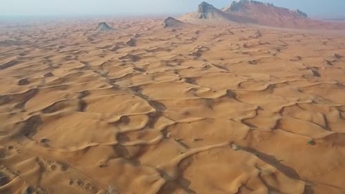 Stunning Drone Footage of a Serene Desert Landscape with Rolling Sand Dunes