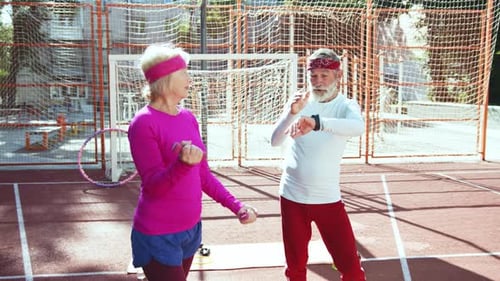 Mature Couple Working Out on Sports Court