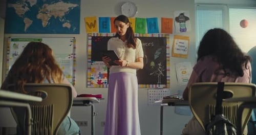 Female Teacher Educating Renewable Energy to Elementary School Students Using Tablet Computer