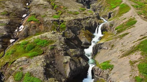 Waterfall in Highlands Mountain River Inside the Canyon Magical Scenic Aerial Drone Shot Iceland at