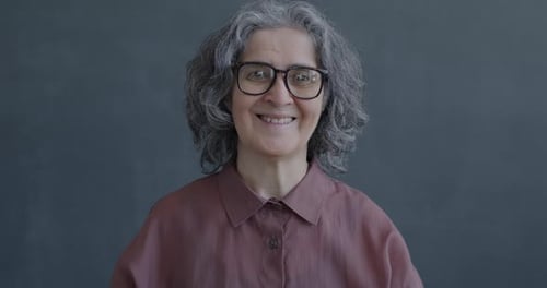 Slow Motion Portrait of Happy Senior Woman Showing Thumbsup Hand Gesture Smiling
