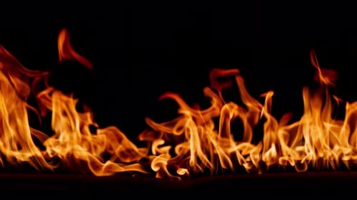 Dynamic Fire Flames Flickering Against Black Backdrop