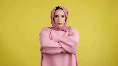 Woman in Headscarf Crosses Arms and Laughs
