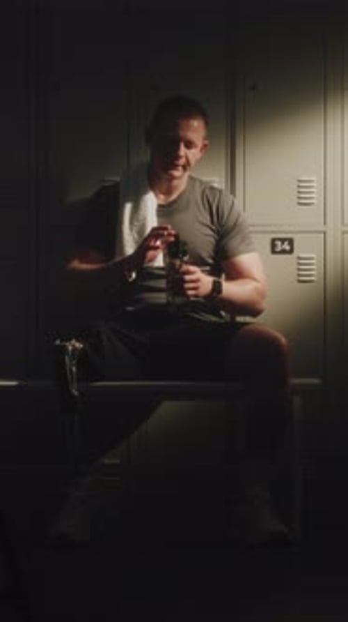 Young Man with Prosthetic Leg Leaning Back Against Lockers
