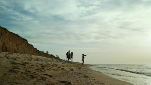 Parents Child Enjoying Sea Waves on Sand Beach. Family Loving Ocean Coast