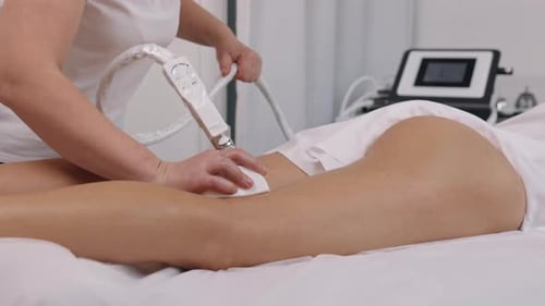 Woman Receiving Laser Treatment on Her Leg and Buttocks