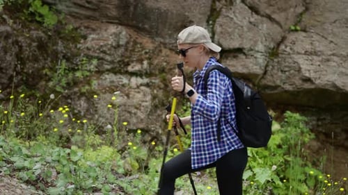 A Young Athletic Woman Goes Hiking in the Mountains Summer Season of Mountain Climbing and Trekking