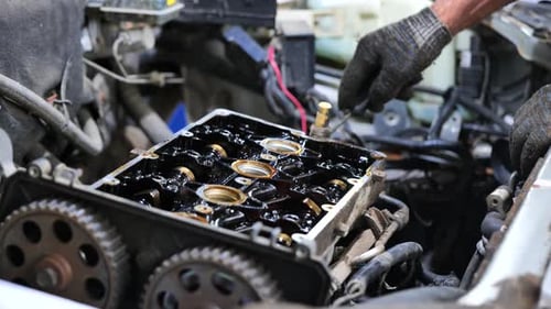 Mechanic Repairing Car Engine at Auto Service Station