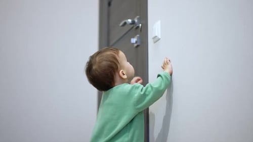 Infant Turns Off Light Switch in Dark Room