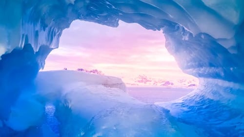 Blue Ice Cave Covered with Snow Flooded with Light