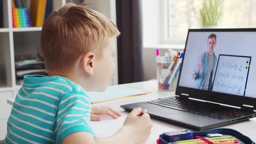 Boy Studying Using Laptop at Home with Teacher