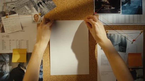 Paper Pinned to a Corkboard With Documents