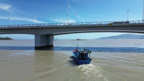Fishermen Come Out of the Boat Bay Under the City Bridge