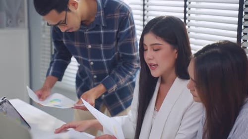 Group of Asian businessman and businesswoman working in the office.