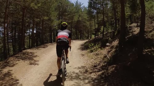 Cyclist Male Pedaling a Gravel Bike Down the Mountain