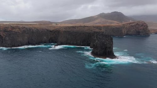 The Silhouette of the Farallón of Gran Canaria in a Restless Sea