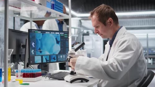 Scientist Uses Microscope in a Modern Laboratory