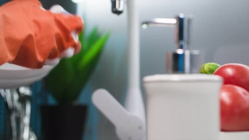Daily Household Chores Young Woman in Gloves with a Sponge in Her Hands Washing Dishes in Cold Water
