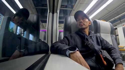 Man Travels by Train in Daytime
