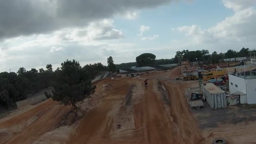 Dirt Bike Racing Across Sandy Hills Aerial