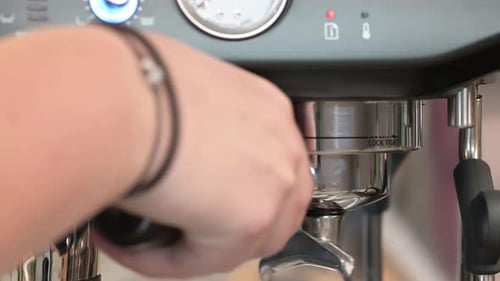 Barista puts holder from coffee close-up