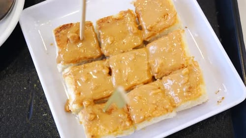 Top View of Peanut Butter and a Bread on Plate on Black Background