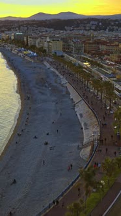 View of coastline of the city in the French Riviera at sunset. Vertical, Nice, France
