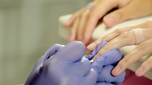 Manicurist Applying Nail Polish in Beauty Salon
