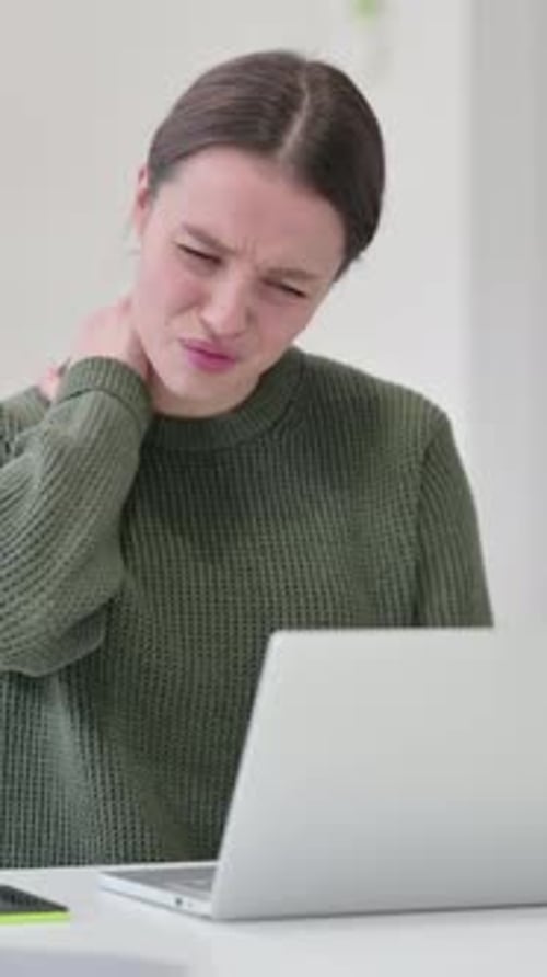 Young Woman Experiencing Neck Pain While Using Laptop