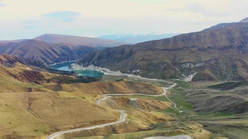 Aerial Scenic Mountain Road From a Pass to Alpine Lake in Spring Mountain