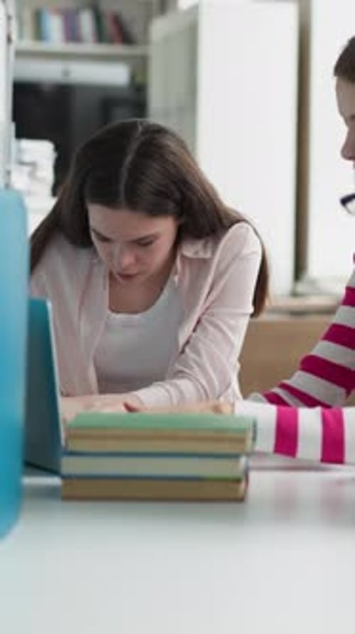 Students Search Online Sources in Library