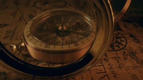 Vintage Compass and Magnifying Glass on Aged Map