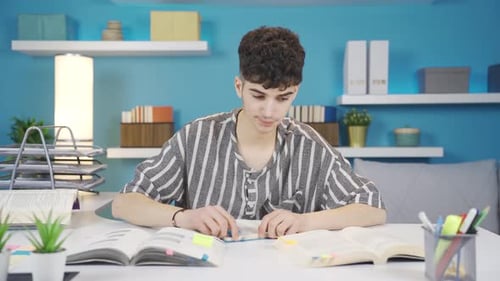 Teenage Boy Studies with Frustration at Desk