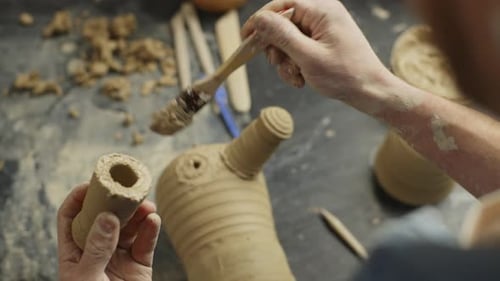 Closeup of a Male Potter Sculpting a Figurine From Clay in the Workshop