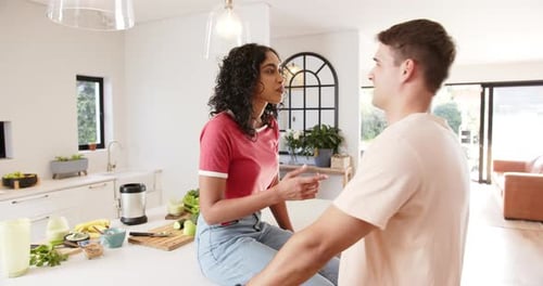 Woman and Man Talking in Modern Kitchen