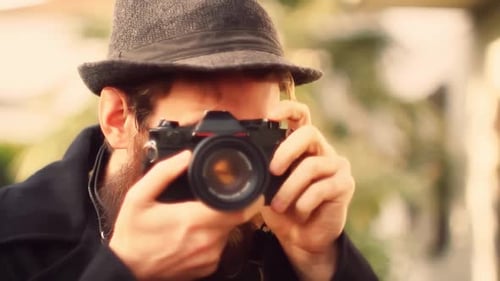 Adult Man Taking Photos with Camera Close Up