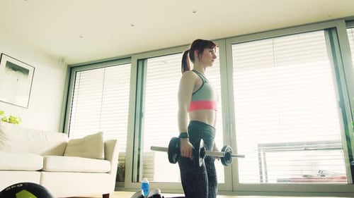 Woman Exercising with Dumbbells in Modern Living Room
