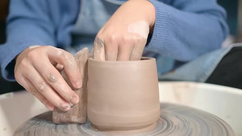 Pottery artist, Young female making a piece of clay molding calmly