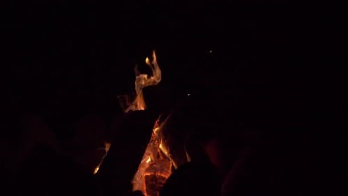 Slow motion campfire with stacked wood crackles and glows