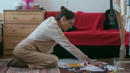 Woman Painting Indoors on the Floor