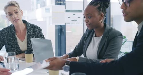 4k video footage of a group of businesspeople using a digital tablet during a meeting in an office