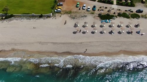 Aerial Drone Top-Down View Flies Along Beach, Tilting Up to Reveal Long Sandy Coastline,