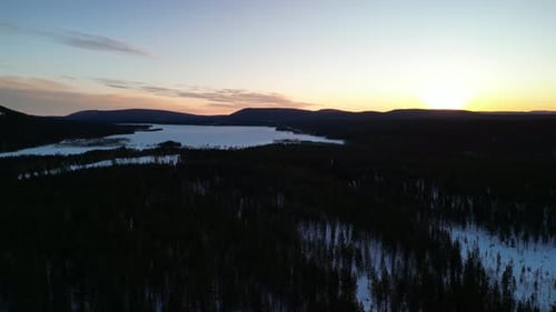 Aerial view of winter landscapes with snow-covered forest in Finland