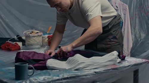 Young Concentrated Craftsman Redesigning Jacket in Workshop