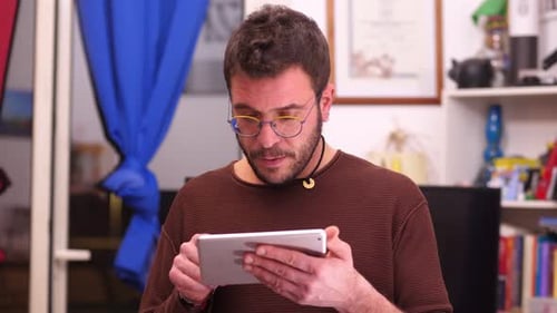 Man Using Digital Tablet Indoors at Home