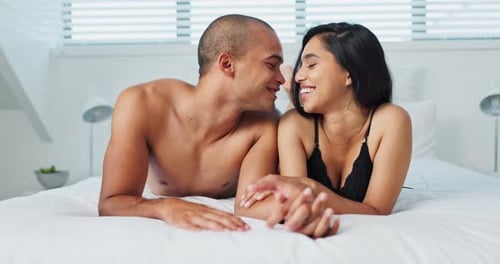 Loving Couple Smiling Together in Bed