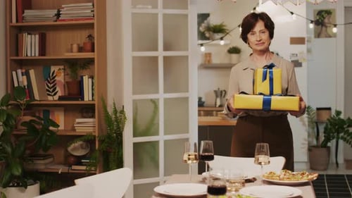 Woman Holding Birthday Gifts in Dining Room