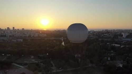 Aerial Shot Of Hot Air Balloon Descending Over Yarkon Park Against Sky In City