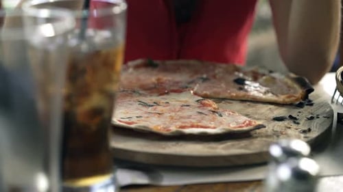 Young Woman Eating Pizza Sitting in Cafe in City 30s