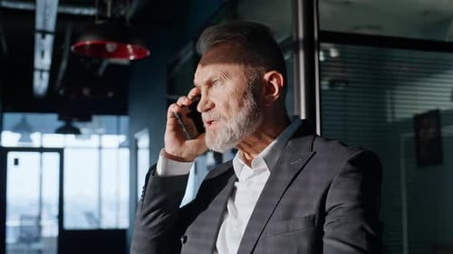 Angry Businessman Yelling on Phone in Office